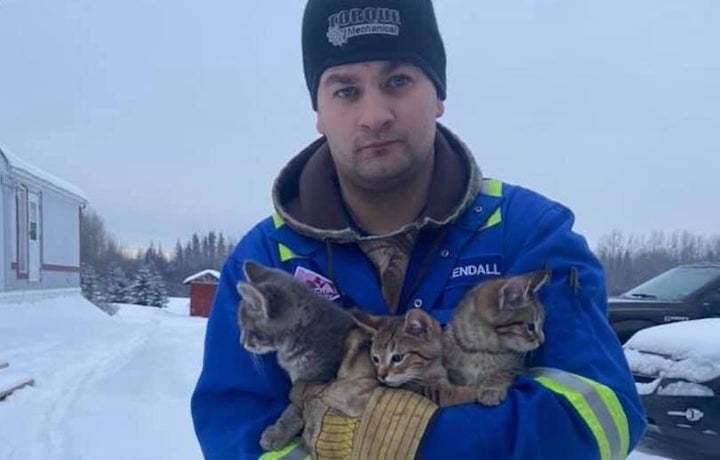 Kendall Diwisch poses for a photo with the three kittens he rescued from the bitter cold.