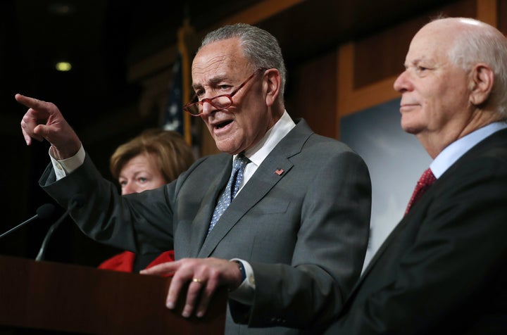 Senate Minority Leader Chuck Schumer speaks as Sen. Ben Cardin (right) and Sen. Tammy Baldwin (left) look on at a news confer