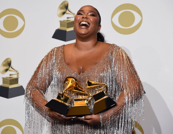 Lizzo poses poses with her Grammy awards on Sunday.