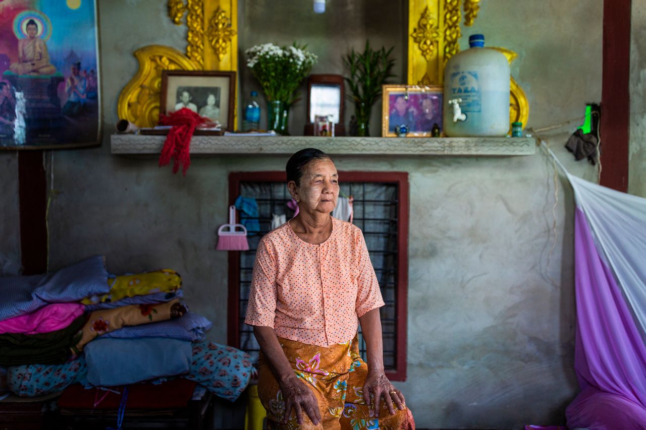 Daw San Aye, 72, poses for a portrait in Yangon division, Myanmar. She says life has improved since plastic has been introduced in the area.