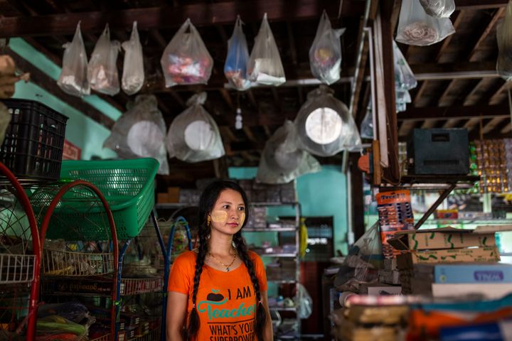 Lai Lai Swe, 32, poses in her shop in Mingalun village, in Yangon division, Myanmar.