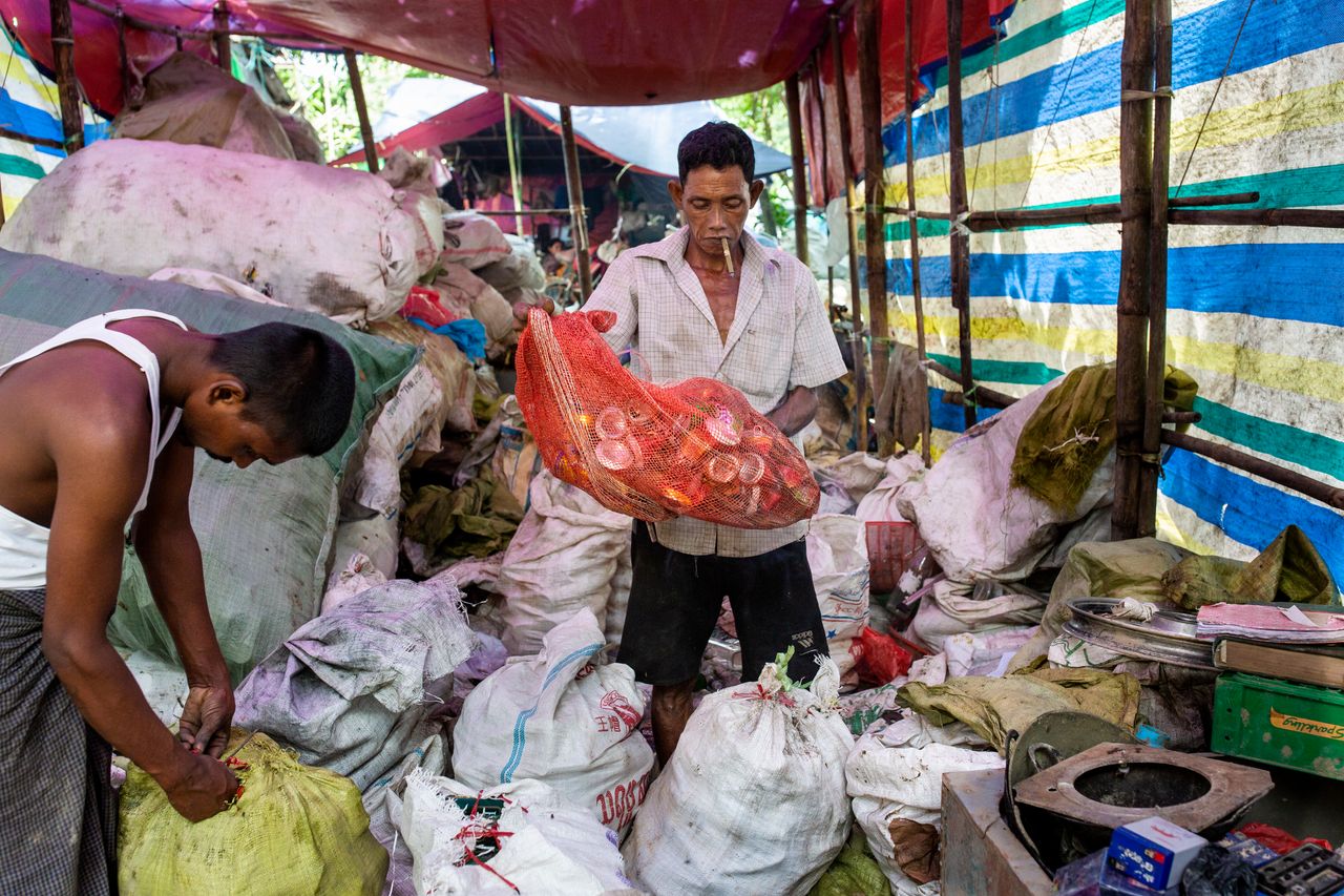 A man organizes materials at the recycle shop before sending them to the recycling factory.