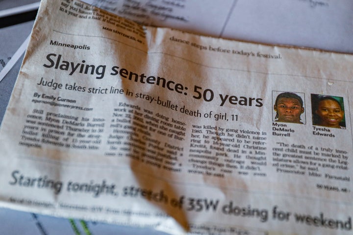 Ianna Burrell displays a newspaper clipping that followed the murder trial of her brother, Myon Burrell, at her home in Shako