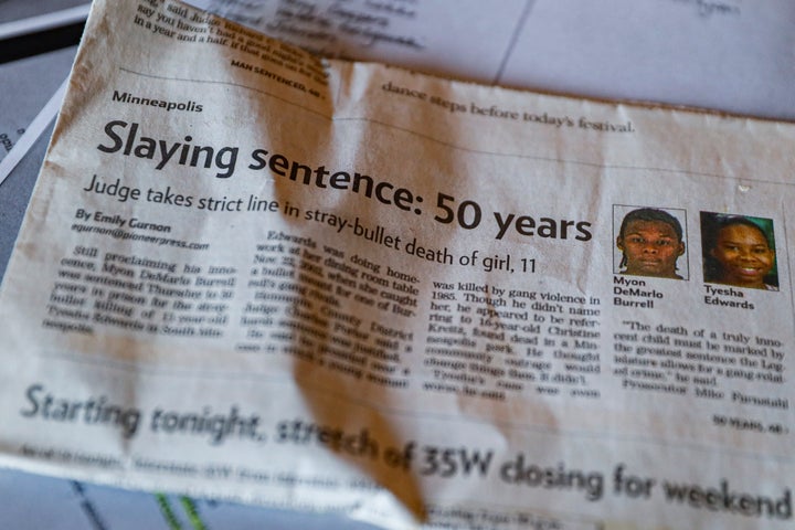 Ianna Burrell displays a newspaper clipping that followed the murder trial of her brother, Myon Burrell, at her home in Shakopee, Minn., Friday, Oct. 25, 2019. (AP Photo/John Minchillo)