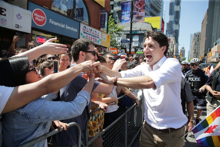 Prime Minister Justin Trudeau greets people as he joins supporters of Toronto's LGBTQ community as they march in one of North America's largest Pride parades, in Toronto on June 23, 2019. 