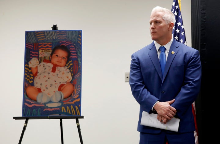 Yolo County District Attorney Jeff Reisig stands next to a photo of Kato Krow Perez, born in 2001. Kato was one of five infants believed to have been killed by their father.