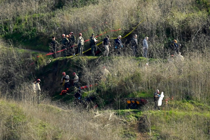 Investigators work the scene of a helicopter crash that killed former NBA basketball player Kobe Bryant, his 13-year-old daughter, Gianna, and several others Monday, Jan. 27, 2020, in Calabasas, Calif. (AP Photo/Mark J. Terrill)