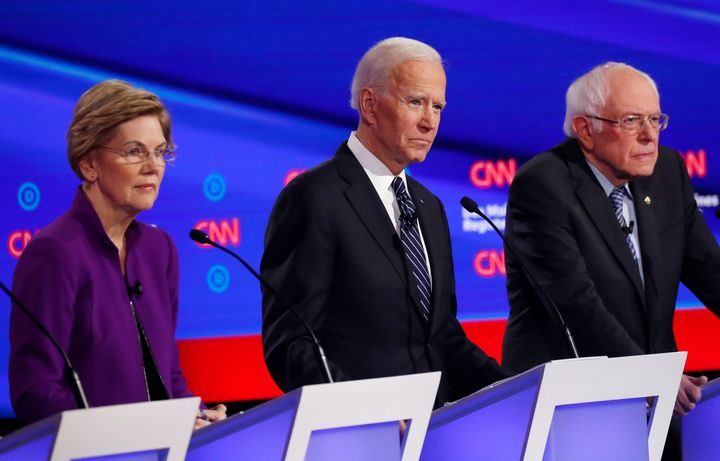Sen. Elizabeth Warren, former Vice President Joe Biden and Sen. Bernie Sanders participate in the seventh Democratic presidential debate in Des Moines, Iowa, on Jan. 14, 2020.