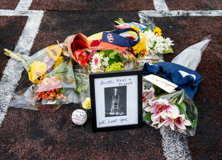 A makeshift memorial was created on home plate Orange Coast College baseball field in Costa Mesa, Calif. on Sunday, Jan. 26, 2020 for Orange Coast College baseball Coach Altobelli, his wife Keri and daughter Alyssa who were killed in the helicopter crash that also killed former Lakers star Kobe Bryant. (Leonard Ortiz/The Orange County Register via AP)