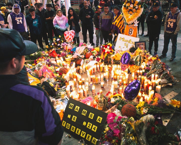 Fans gather outside of the Staples Center in Los Angeles to mourn Los Angeles Lakers legend Kobe Bryant.