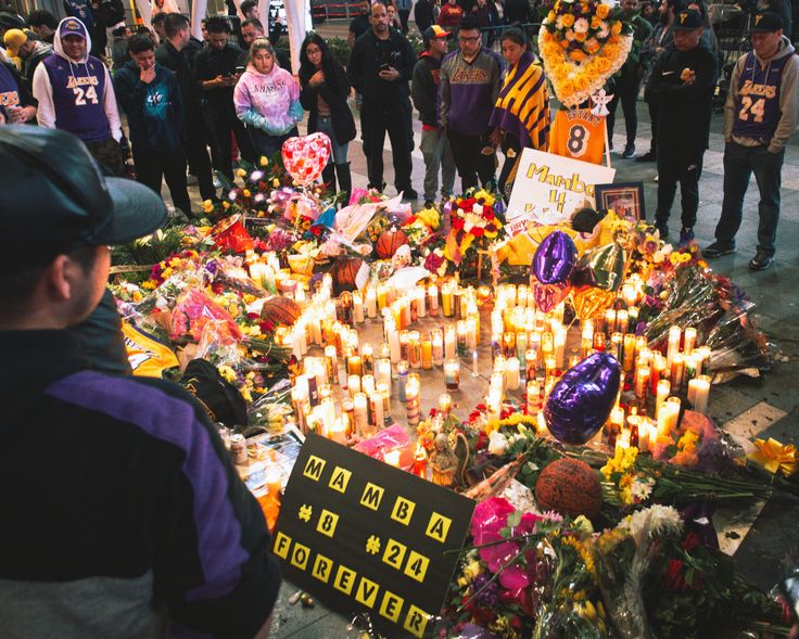 Fans gather outside of the Staples Center in Los Angeles to mourn Los Angeles Lakers legend Kobe Bryant.