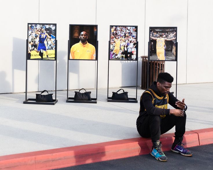 A fan sits outside of the Los Angeles Lakers training facility in El Segundo, California.