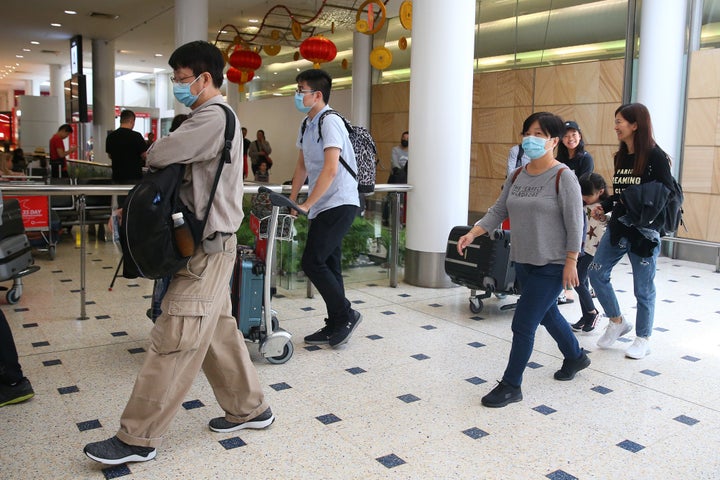 Passengers arrive at Sydney International Airport on January 23. The flight from Wuhan departed the Chinese city prior to officials temporarily closing down transportation from the city.