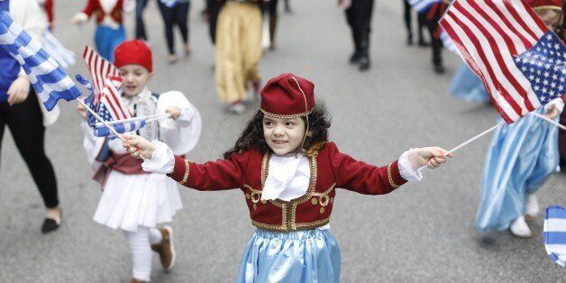 BOSTON, MA - APRIL 30: Christine Konstantilakis, 4, waves Greek and American flags during the Greek Independence Day parade in Boston on Apr. 30, 2017. (Photo by Keith Bedford/The Boston Globe via Getty Images)