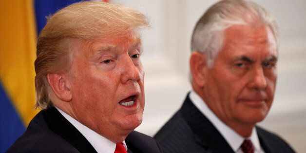 U.S. President Donald Trump speaks as U.S. Secretary of State Rex Tillerson (R) looks toward him during a working dinner with Latin American leaders in New York, U.S., September 18, 2017. REUTERS/Kevin Lamarque