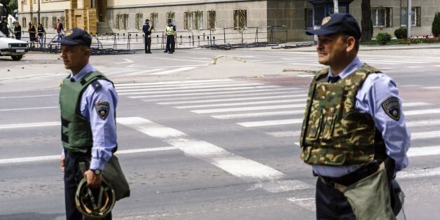 Policemen stand guard near Macedonia's parliament building in downtown Skopje on April 28, 2017 a day after violence erupted after nationalist protesters stormed the building in anger over a vote for a new speaker.The chaos in Skopje broke out on April 27, 2017 in the evening, with dozens of demonstrators -- including a group of masked men -- breaking a police cordon and entering parliament waving Macedonian flags, shouting and singing the national anthem. / AFP PHOTO / DIMITAR DILKOFF (Photo credit should read DIMITAR DILKOFF/AFP/Getty Images)