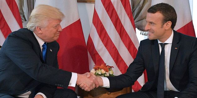 US President Donald Trump (L) and French President Emmanuel Macron (R) shake hands ahead of a working lunch, at the US ambassador's residence, on the sidelines of the NATO (North Atlantic Treaty Organization) summit, in Brussels, on May 25, 2017. / AFP PHOTO / Mandel NGAN (Photo credit should read MANDEL NGAN/AFP/Getty Images)
