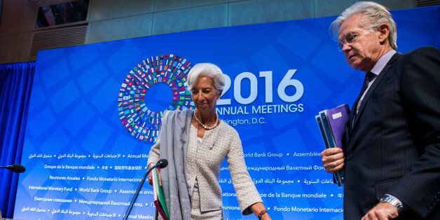 IMF Managing Director Christine Lagarde and IMF Spokesman Gerry Rice take their seats at the start of a press conference at the 2016 Annual Meetings of the International Monetary Fund Headquarters and the World Bank Group at the IMF on October 6, 2016 in Washington, DC. / AFP / ZACH GIBSON (Photo credit should read ZACH GIBSON/AFP/Getty Images)