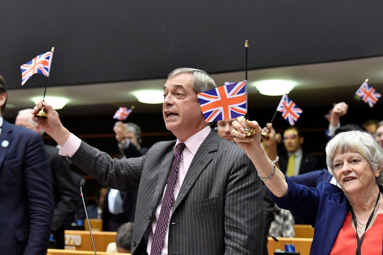 Brexit Party leader Nigel Farage holds a union flag during a European Parliament plenary session in Brussels. 