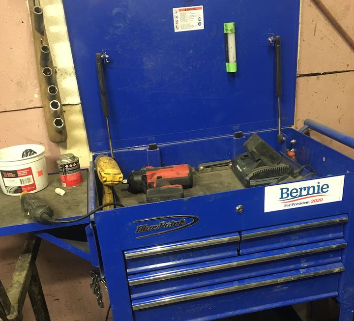 Luis Gomez promotes the candidacy of Sen. Bernie Sanders (I-Vt.) at his auto body repair shop in Des Moines.