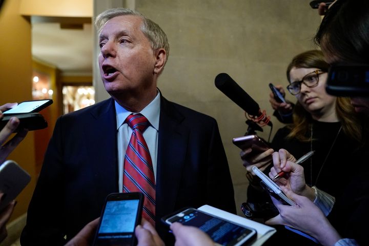 Sen. Lindsey Graham (R-SC) speaks to reporters Tuesday as he leaves a closed-door Senate Republican caucus meeting after the Senate adjourned for the day during the impeachment trial.