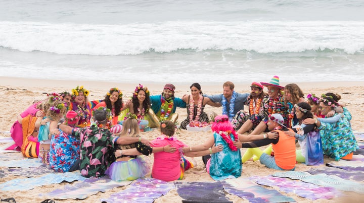 Harry and Meghan in an "anti-bad vibes circle" with members of the surf and mental health group OneWave at Bondi Beach in Sydney, Australia, on Oct. 19, 2018.