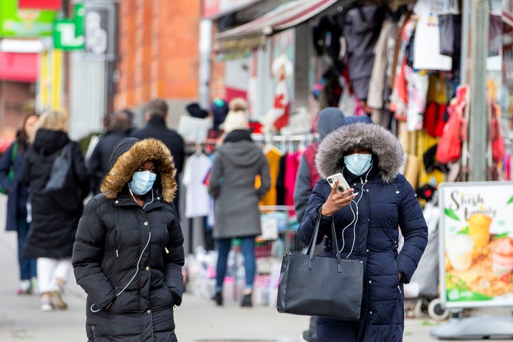 Pedestrians walk in the Chinatown district of downtown Toronto on Jan. 28, 2020. 