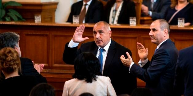 Bulgaria's new centre-right Prime Minister Boyko Borisov (C) waves during an official swearing-in ceremony for his cabinet on May 4, 2017 at the parliament in Sofia. The leader of Bulgaria's centre-right Boyko Borisov on May 3 nominated four representatives of a nationalist alliance as ministers in his proposed new cabinet. The list was due to be presented to the president and to parliament for approval on May 4. The expected green light will make Borisov, 57, prime minister for the third time. / AFP PHOTO / NIKOLAY DOYCHINOV (Photo credit should read NIKOLAY DOYCHINOV/AFP/Getty Images)