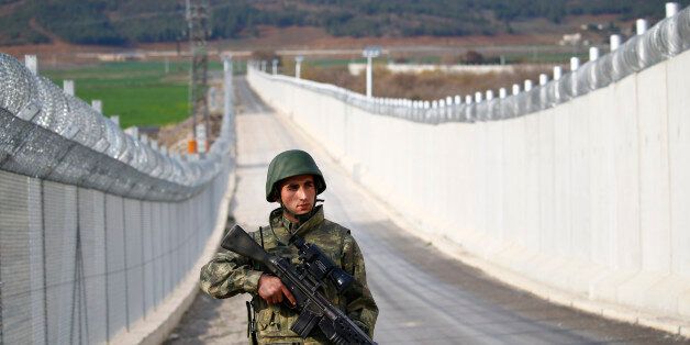 A Turkish soldier patrols along a wall on the border line between Turkey and Syria near the southeastern city of Kilis, Turkey, March 2, 2017. REUTERS/Murad Sezer