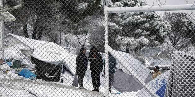 Migrants stand next to their tents at the Moria hotspot on the island of Lesbos , following heavy snowfalls on January 7, 2017. The number of migrants arriving in Europe by two main sea routes in 2016 plunged by almost two-thirds to 364,000 compared with the previous year, EU border agency Frontex said Friday. Frontex pointed to an EU border deal with Turkey which came into effect in March as having paved the way to a massive decline in the arrival of Syrian refugees and other migrants in Greece