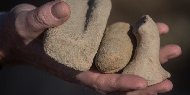 KOS, GREECE - OCTOBER 07: Detective Inspector Jon Cousins of the South Yrokshire Police displays pieces of ancient artifacts found during the excavation of soil deposits at the second search site, approximately 1km from the search site at the farmhouse, during the search for missing toddler Ben Needham on October 7, 2016 in Kos, Greece. The 21 month old toddler from Sheffield vanished on the Greek island in July of 1991. A 19-strong team of police officers, forensic specialists and an archaeologist have been searching an olive grove next to the farm for the past twelve days and have now begun work on a second site, where rubble from the farmhouse was deposited in the days after Ben Needham's disappearance. (Photo by Chris McGrath/Getty Images)