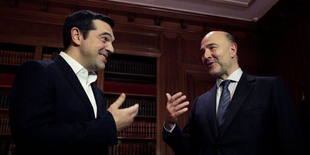 Greek Prime Minister Alexis Tsipras, left, meets with European Commissioner for Economic and Financial Affairs Pierre Moscovici in Athens, on Tuesday, Nov. 3, 2015. Moscovici's talks with officials in Greece's leftwing government will focus on the progress of reforms demanded by the country's European creditors in return for a third multi-billion euro bailout. (AP Photo/Petros Giannakouris)
