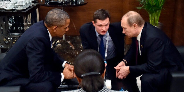 U.S. President Barack Obama, left, speaks with Russian President Vladimir Putin, right, prior to the opening session of the G-20 summit in Antalya, Turkey, Sunday, Nov. 15 2015. The 2015 G-20 Leaders Summit is held near the Turkish Mediterranean coastal city of Antalya on Nov. 15-16, 2015. (RIA-Novosti, Kremlin Pool Photo via AP)