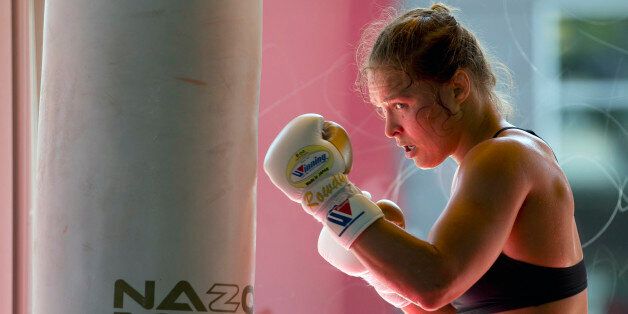 FILE - This July 15, 2015, file photo shows mixed martial arts fighter Ronda Rousey working out at Glendale Fighting Club in Glendale, Calif. Rousey's star power grows with each month, and the UFC's dominant bantamweight champion could have held her next title defense anywhere. She chose to travel to Bethe Correia's native Brazil for UFC 190 on Saturday, Aug. 1, just so she can embarrass the challenger in front of her home fans. (AP Photo/Jae C. Hong,File)