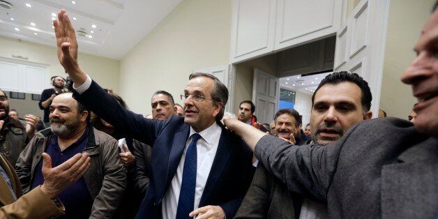 Greece's Conservative Prime Minister Antonis Samaras waves to his supporters as he arrivess at Zappeio Conference Hall in Athens, Sunday, Jan. 25, 2015. A Greek state TV exit poll was projecting that anti-bailout party Syriza had won Sundayâs parliamentary elections _ in a historic first for a radical left wing party in Greece. (AP Photo/Thanassis Stavrakis)
