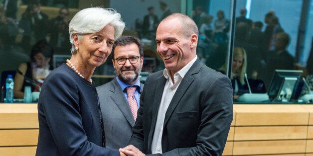 Managing Director of the International Monetary Fund Christine Lagarde, left, greets Greek Finance Minister Yanis Varoufakis during a meeting of eurozone finance ministers in Brussels on Thursday, June 25, 2015. Greece and its creditors launched a new round of talks in Brussels early Thursday in a fresh bid to unlock billions of euros in loans and save the country from bankruptcy. (AP Photo/Geert Vanden Wijngaert)