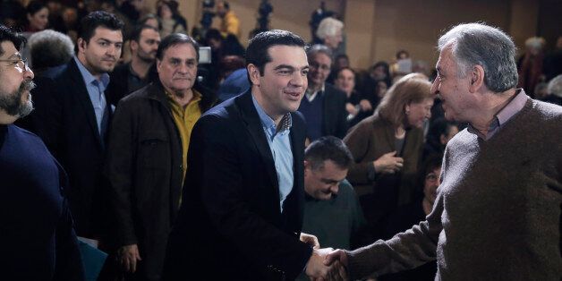 Greek Prime Minister and Syriza leader Alexis Tsipras, centre, arrives at his party central committee, in Athens, on Saturday, Feb. 28, 2015. Greece's new radical left government has no intention of seeking yet another bailout deal from international creditors and will spend coming months trying to ease the terms of its current commitments, the financially struggling country's prime minister said Friday.(AP Photo/Petros Giannakouris)