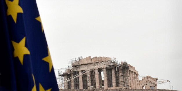 EU flag flies near the Acropolis in Athens on January 1, 2014. Greece on January 1, 2014 began a six-month stint as president of the European Union, as it continues its own struggle against recession and social unrest. Athens assumes the bloc's rotating presidency at a time of change, with elections in May set to usher in a new European parliament amid fears of gains by anti-EU parties. AFP PHOTO / Louisa Gouliamaki (Photo credit should read LOUISA GOULIAMAKI/AFP/Getty Images)