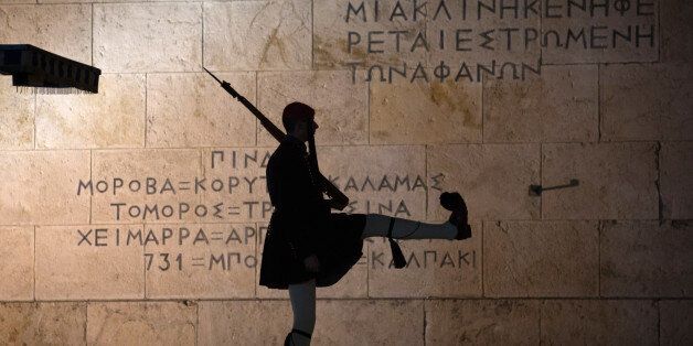 ATHENS, GREECE - JANUARY 21: Greek Presidential Guard soldiers perform their duties in front of the the Greek Tomb of the Unknown Soldier beneath the Hellenic Parliament which is home to the Greek parliament ahead of this weekend general election on January 21, 2015 in Athens, Greece. According to the latest opinion polls, the left-wing Syriza party are poised to defeat Prime Minister Antonis Samaras' conservative New Democracy party in the election, which will take place on Sunday. European leaders fear that Greece could abandon the Euro, write off some of its national debt and put an end to the country's austerity by renogotiating the terms of its bailout if the radical Syriza party comes to power. Greece's potential withdrawal from the eurozone has become known as the 'Grexit'. (Photo by Matt Cardy/Getty Images)