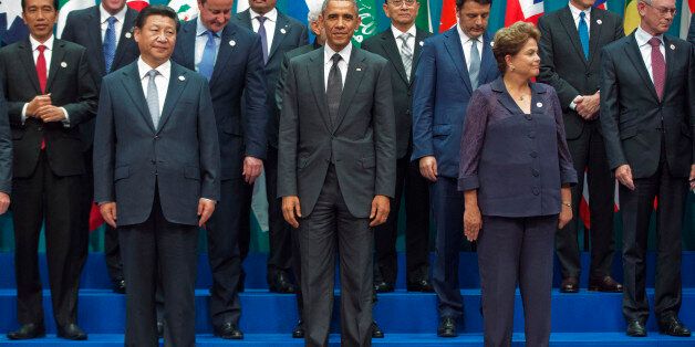 U.S. President Barack Obama, center, with other world leaders gather during the G20 Summit family photo in Brisbane, Australia, Saturday, Nov. 15, 2014. With Obama are from left to right, Indonesian President Joko Widodo, Prime Minister of New Zealand, John Key, Chinese President Xi Jinping, British Prime Minister David Cameron, President of Mauritania Mohamed Ould Abdel Aziz, Prime Minister of India Narendra Modi, Myanmar's President Thein Sein, Italian Prime Minister Matteo Renzi, Brazilian Pr