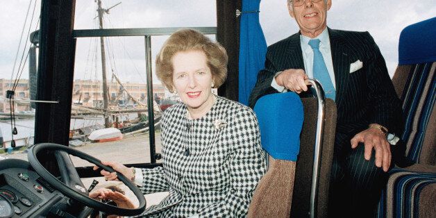 British Prime Minister Margaret Thatcher at the wheel of her bullet-proof, anti-terrorist campaign bus in London?s Docklands on Thursday, May 21, 1987. The ?Tory blue? Leyland coach is equipped with sophisticated communications technology and painted with the slogan ?Moving forward with Maggie.? (AP Photo/David Caulkin)