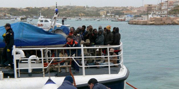 An Italian Coast Guard boat carrying some would-be immigrants, rescued at sea, reaches the port of the tiny Italian island of Lampedusa in this March 29, 2009 photo made available Tuesday, March 31, 2009. Vessels carrying hundreds of migrants capsized off the coast of Libya in separate incidents over the last two days and more than 300 people were believed to have drowned, an international migration group said Tuesday. (AP Photo)