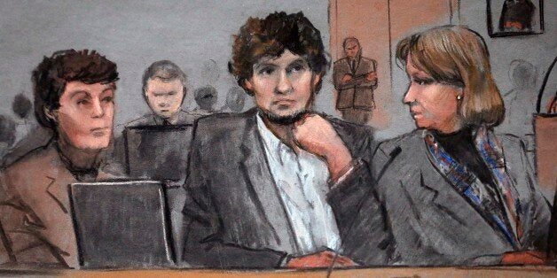 In this courtroom sketch, Dzhokhar Tsarnaev, center, is depicted between defense attorneys Miriam Conrad, left, and Judy Clarke, right, during his federal death penalty trial, Thursday, March 5, 2015, in Boston. Tsarnaev is charged with conspiring with his brother to place two bombs near the Boston Marathon finish line in April 2013, killing three and injuring 260 people. (AP Photo/Jane Flavell Collins)