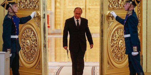 Russian President Vladimir Putin enters a hall before a meeting of the Victory Organizing Committee at the Kremlin in Moscow on March 17, 2015. The meeting focuses on preparations for celebrating the 70th anniversary of the victory in World War II. AFP PHOTO / POOL / SERGEI ILNITSKY (Photo credit should read SERGEI ILNITSKY/AFP/Getty Images)