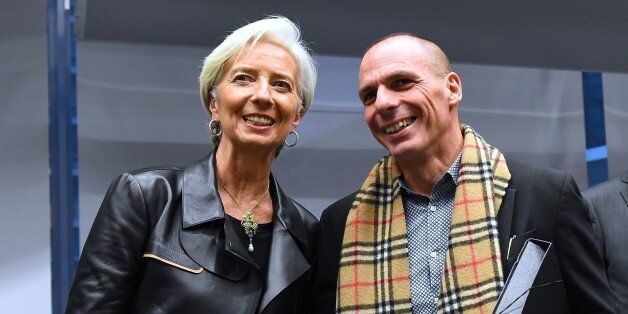 Greek Finance Minister Yanis Varoufakis (R) shakes hands with International Monetary Fund (IMF) Director Christine Lagarde during an emergency Eurogroup finance ministers meeting at the European Council in Brussels on February 11, 2015. Proposals by the new government in Athens to renegotiate the terms of its massive international bailout are scheduled to be discussed by eurozone finance ministers in Brussels on February 11 and 12. AFP PHOTO / EMMANUEL DUNAND (Photo credit should read EMM