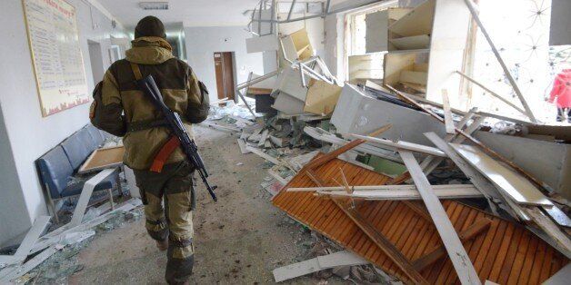 A pro-Russian rebel walks in the hospital of Donetsk's Tekstilshik district after it was hit by a shelling, on Febuary 4, 2015. At least 12 people were killed in fighting between soldiers and pro-Russian separatists in east Ukraine, including four civilians who died when a hospital was hit in rebel stronghold Donetsk today. AFP PHOTO / DOMINIQUE FAGET (Photo credit should read DOMINIQUE FAGET/AFP/Getty Images)