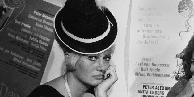 Swedish actress Anita Ekberg wears a Bavarian hat in one of the beer tents at the October Festival in Munich, Germany, Sept. 20, 1965. (AP Photo)