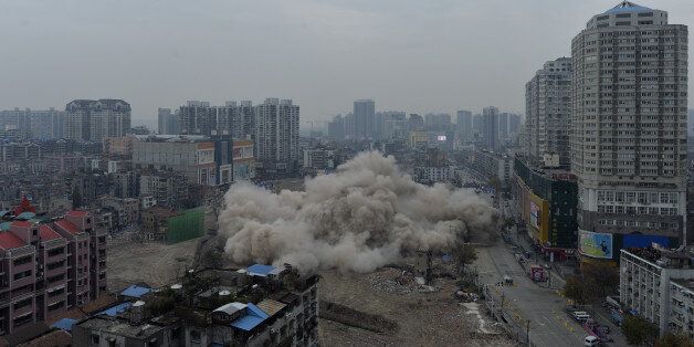 WUHAN, CHINA - DECEMBER 09: (CHINA OUT) 77-meter Yinfeng hotel is demolished by blasting on December 9, 2014 in Wuhan, Zhejiang province of China. Three buildings were demolished by blasting including the 77-meter Yinfeng hotel on Tuesday in Wuhan. (Photo by ChinaFotoPress/ChinaFotoPress via Getty Images)