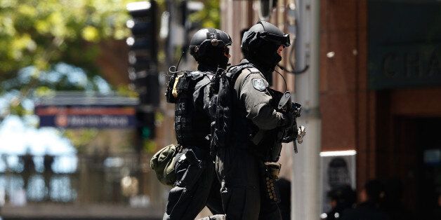SYDNEY, AUSTRALIA - DECEMBER 15: (AUSTRALIA & NEW ZEALAND OUT) Police secure the area near Lindt Chocolate CafÃ© in Martin Place on December 15, 2014 in Sydney, Australia. Major landmarks in Sydney, including the Sydeny Opera House, have been evacuated as police respond to a hostage situation inside a Martin Place cafe. An armed man believed to be an Islamic terrorist is holding at least 20 people hostage at Lindt Chocolate CafÃ©. (Photo by Daniel Munoz/Fairfax Media via Getty Images)