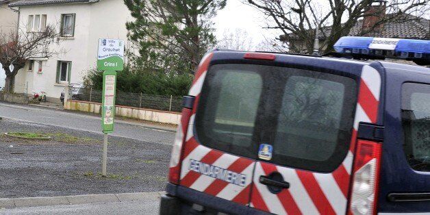 A Gendarmerie vehicle is parked near a house (L) where an alleged jihadist fighter was arrested earlier on December 15, 2014 in Graulhet, southwestern France. French police launched raids across the country early on December 15, dismantling a network sending jihadist fighters to Syria, a police source told AFP. Elite and anti-terror police units descended on around a dozen targets, mostly in the southern region of Toulouse, but also around Paris and in the northern region of Normandy, the source